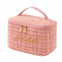 Carica l'immagine nel visualizzatore di Gallery, A pink tweed cosmetic bag with a top handle, gold-tone zipper, and gold accents on a white background.
