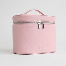 Load image into Gallery viewer, A light pink pebbled faux-leather cosmetic bag with a top handle and a silver zipper closure, shown against a plain white background.
