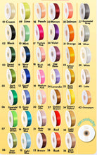 Cargar imagen en el visor de la galería, Color swatch chart with various ribbons in different colors on a yellow background
