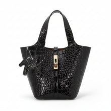 Carica l'immagine nel visualizzatore di Gallery, Black crocodile-embossed handbag with gold zipper on a white background
