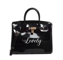 Load image into Gallery viewer, Personalized Beachkin tote black glossy bag with Lovely text and gold lock by Travellers Hat Boutique
