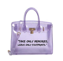 Load image into Gallery viewer, Transparent purple personalized Beachkin tote bag with gold lock and quote Take only memories leave only footprints
