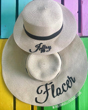 Cargar imagen en el visor de la galería, Custom prenuptial hat set featuring two beige wide-brimmed straw hats with black script names from Travellers Hat Boutique

