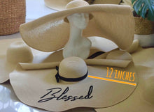 Load image into Gallery viewer, Oversized straw sun hat with a 12 inch wide brim and black ribbon detail from Travellers Hat Boutique
