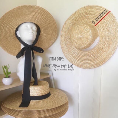 Wheat straw hat with ribbon featuring a wide 5 inch brim and black bow tie from Travellers Hat Boutique